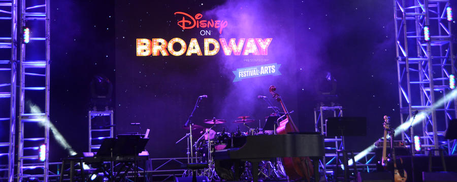 Close-up shot of the concert main stage at the World Showcase with a projected logo still-animation reading "Disney on Broadway Presented by Epcot International Festival of the Arts"